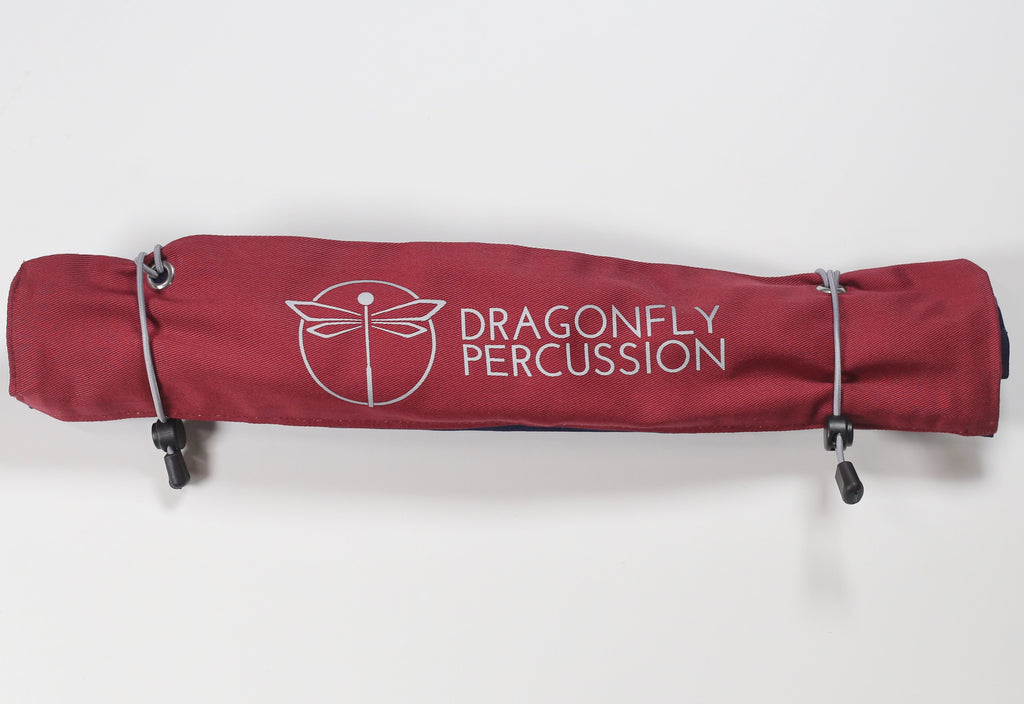 Red roll-bag closed.  Grey Dragonfly Percussion logo on outside.  2 grey elastic closures.