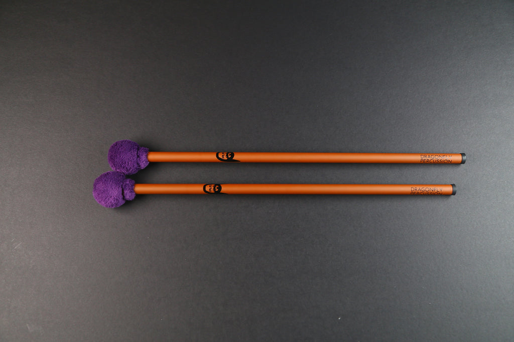 Mike Tamburo Utlitly mallets - a pair of bronze-colored carbon fiber handles with Mike Tamburo's face printed on them.  Heads are small and round and wrapped in purple minty fabric.