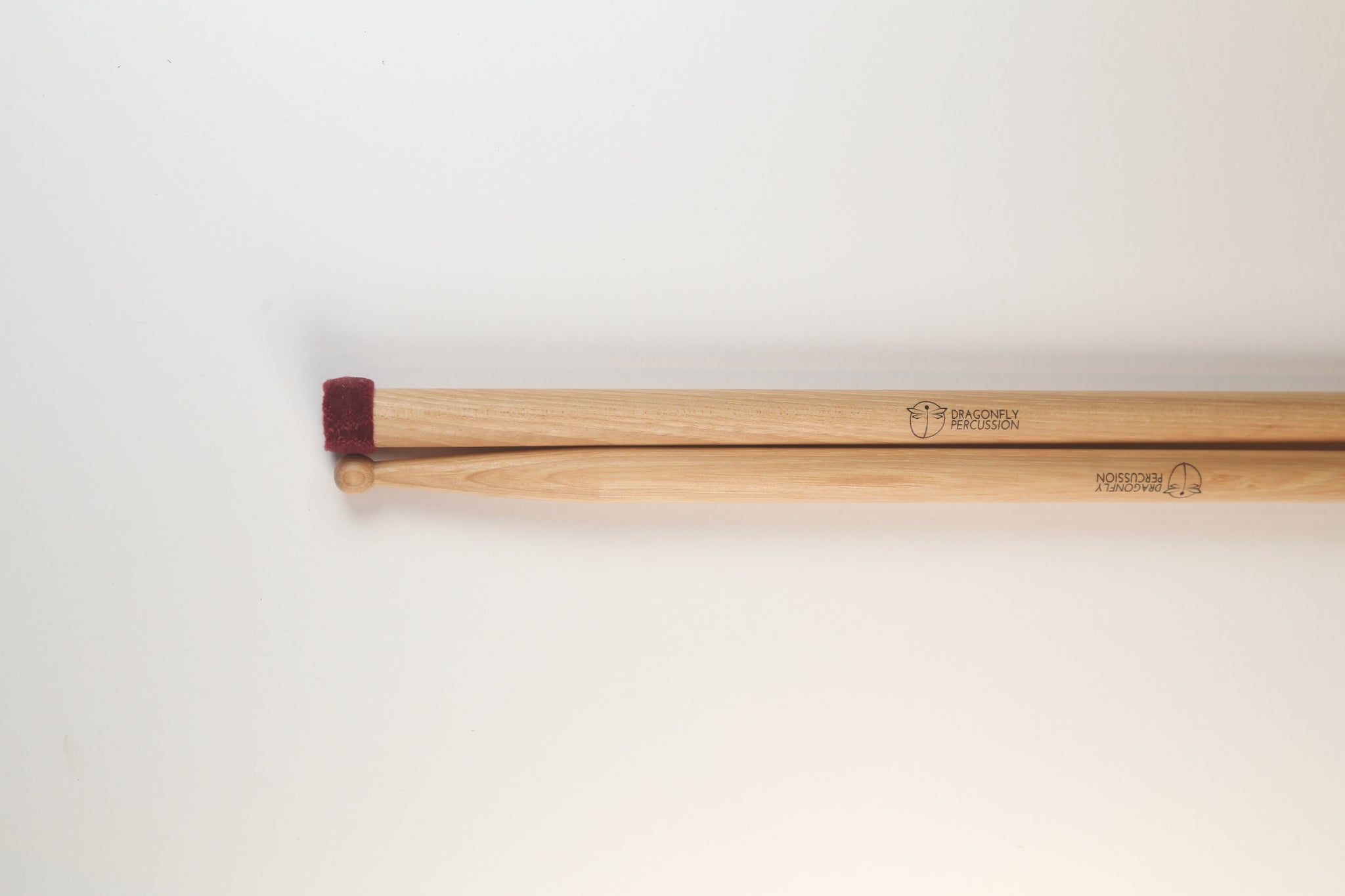 Soft flannel swizzles - Concert General drumsticks with a small head on the butt end made of stacked discs of red flannel.