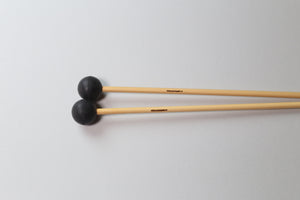 Pair of apartment xylophone mallets - rattan handles with black heads.
