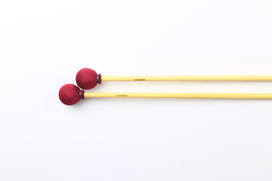 Soft vibraphone mallets with rattan handles and red spandex wrap.
